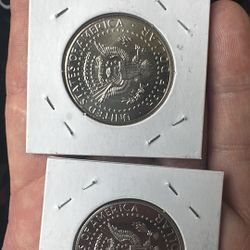  2 half Dollars One Is Finished And The Other Is Not 