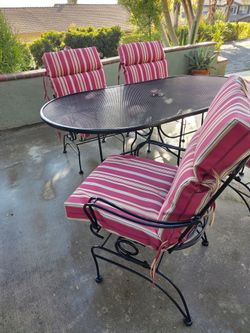 Black Wrought Iron Patio Dinning Set With rocker/bouncy chairs & cushions