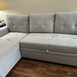 grey pull out couch with storage 