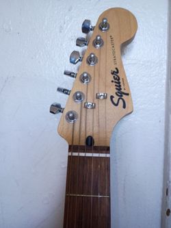Squire fender electric guitar with amp, extra strings, and stand