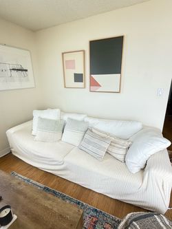 White Slipcovered Sofa with Throw Pillows