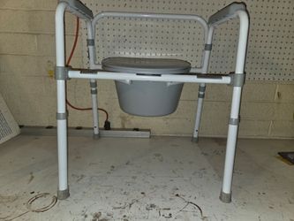 Raised toilet assistant with arm rest