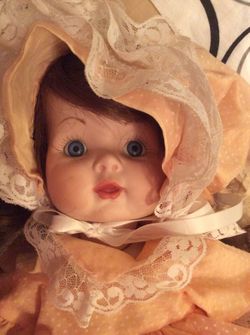 17" porcelain doll with moveable arms, legs, and head. She has beautiful coloring. There is no brand name on this doll.