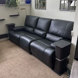 Black faux, leather couch with electric push button seats