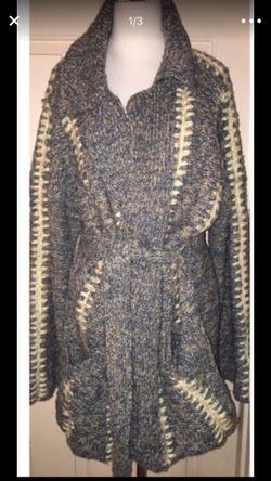 This is a true hippie jacket cardigan sweater made by kennington. There are no rips or TEARS. It also has two pockets on the on the front of the jack