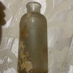 vintage, hand-blown glass apothecary or medicine bottle, likely dating from the late 19th