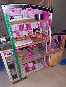 Big play house with toy appliances.