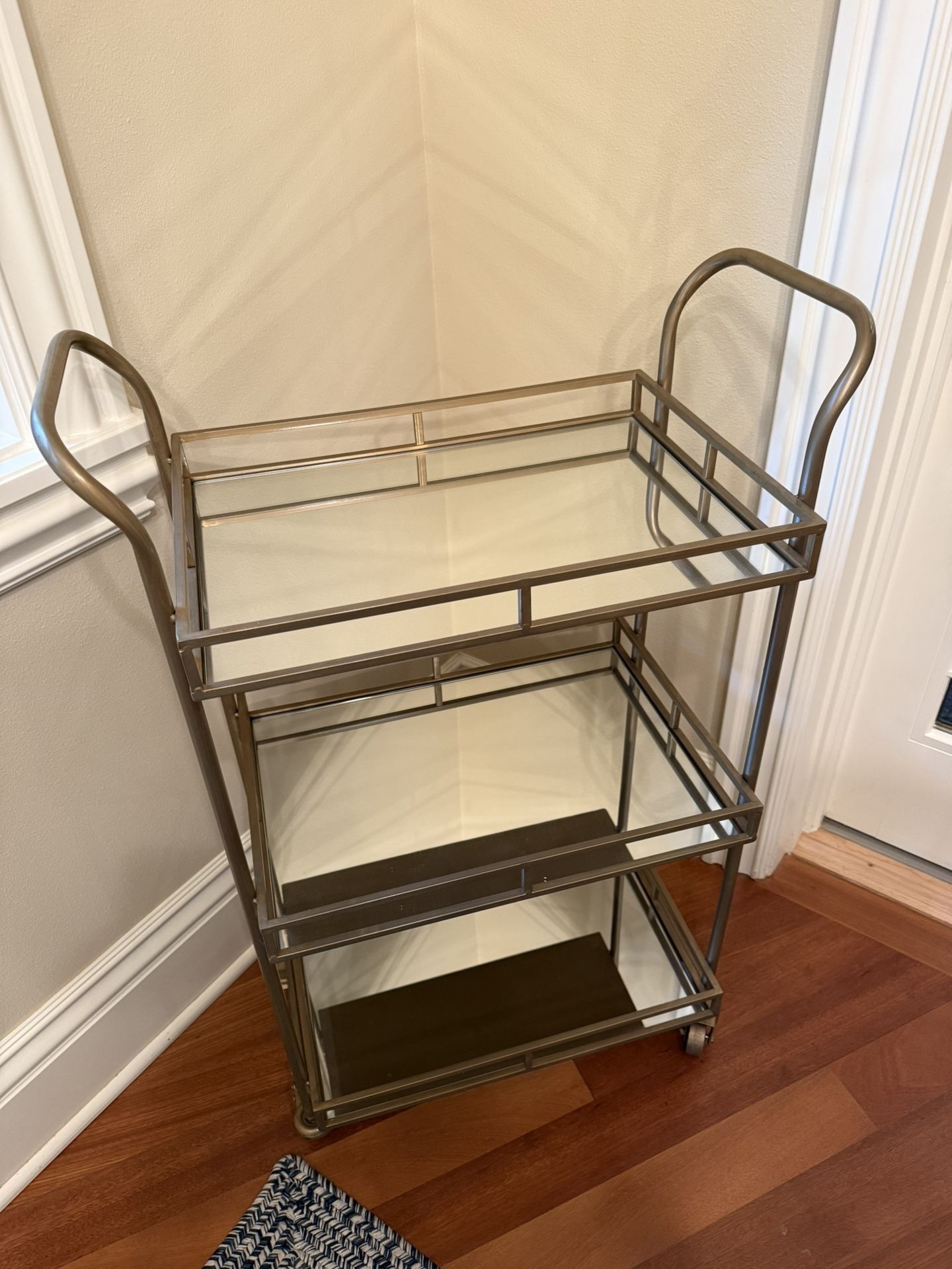 This is a World Market 3-Tier Metal + Glass Bar Cart Gold