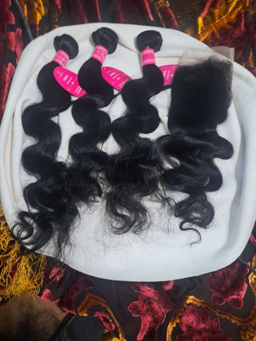 One hundred percent real human hair bundles with a full closure top piece