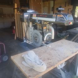 Radio Arm Saw An A Roll Around Tool Box With A Lot Of Tools 