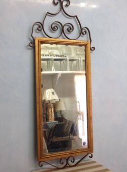 Mid century gold leaf mirror with black iron scroll details