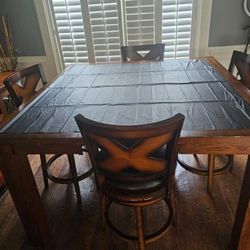 Hardwood  Table With Leather Spin Arond Chairs With Center Pieces  That Can Come To Make The Smaller 