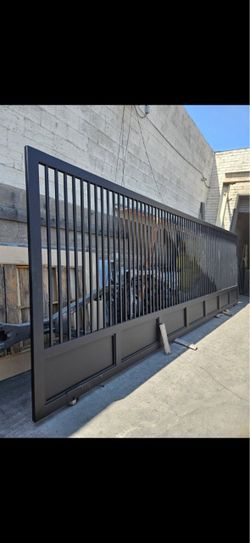 Black metal sliding driveway gate