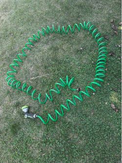 Coil garden hose with nozzle