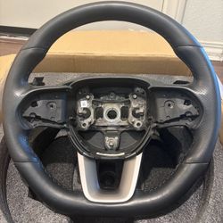 Genuine Mopar flat-bottom, leather-wrapped steering wheel on 2015–2023 Dodge Charger and Challenger models part number 6TU491A5AC