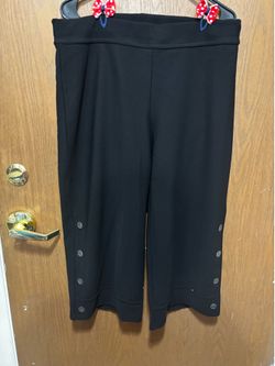 Black high-waisted wide-leg trousers with button details