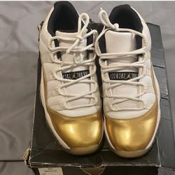 Jordan White and Gold 11 retro Sneakers. 