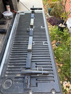 Motorcycle tie down bar for truck bed
