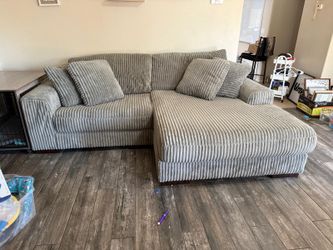 ASHLEY LINDYN COUCH + OVERSIZED SWIVEL CHAIR – $1,250