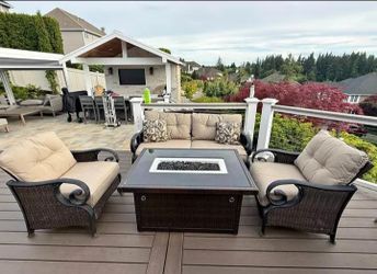 Outdoor lazy boy patio couch and oversize chairs, fire table, and matching umbrella