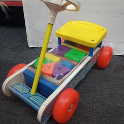 Vintage Fisher-Price Creative Coaster, likely from the 1960s or 1970s. It's a ride-on toy designed for young children, featuring a wooden frame, a yel