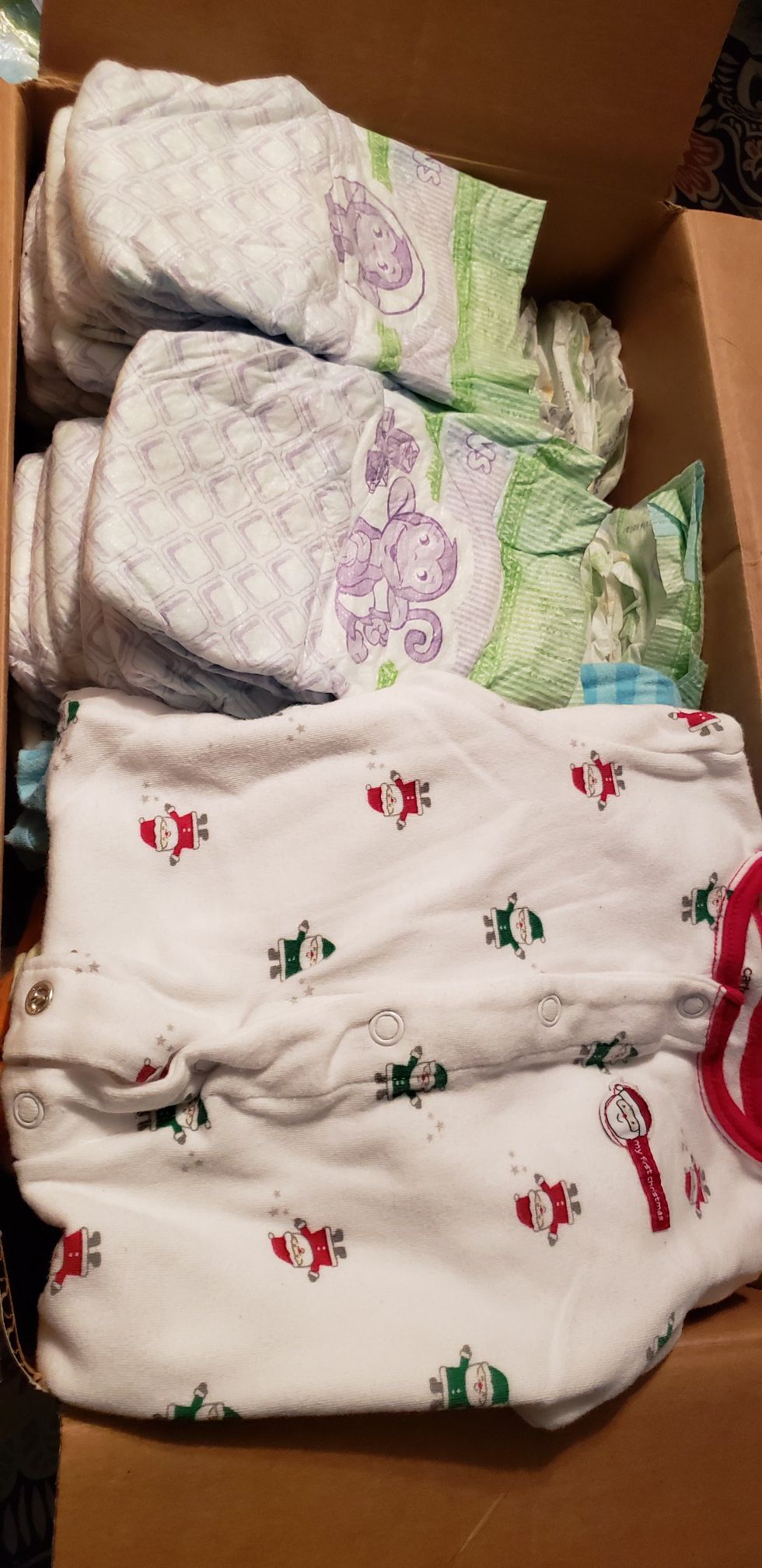 New born boy 16 onies,2 t-shirts,3 pants,5 foot in onies,57 new born Pampers brand new. Slightly worn and new clothes.