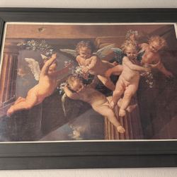 big cherub painting in frame 