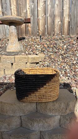Beautiful woven basket with a natural neutral tone and dark accent design