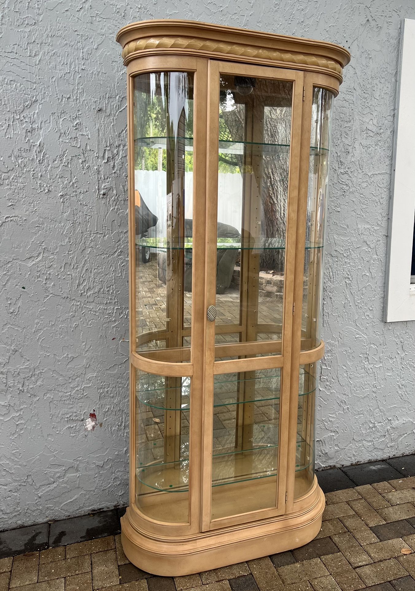 Curved display cabinet with light wood frame and curved glass panels. I can deliver for an additional cost