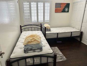 2 twin beds with mattresses