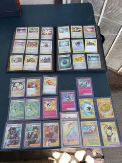 Folder full of Trainers Pink Cards Gold Cards Poke ball Holo Cards & More On table. $1000! All or Trade PS5 Pro Switch 2 Legion Go Iphone pro max Unlo