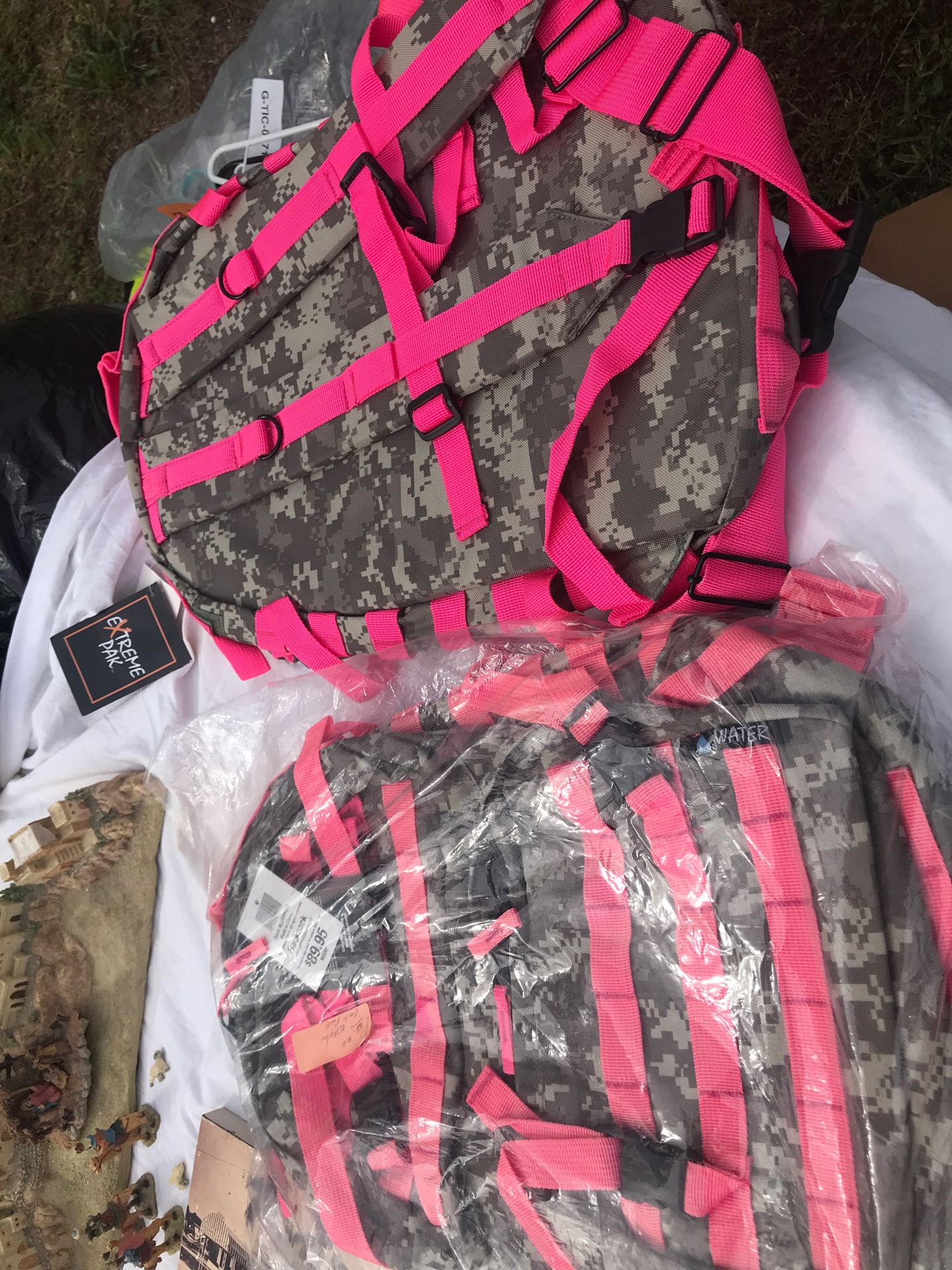 Two backpacks brand new camouflage and pink
