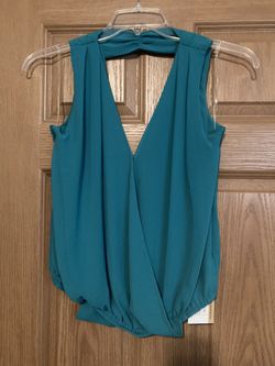 Teal color sleeveless blouse