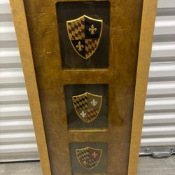Framed medieval shields.. ready to hang by John Richard. 16” x 39” $100