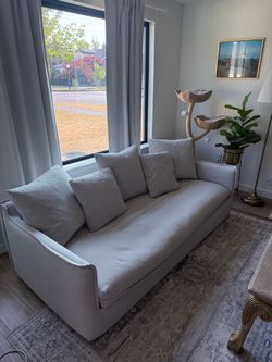 Light Gray Upholstered Sofa with Throw Pillows