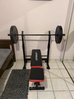 Bench press machine with weights and bar