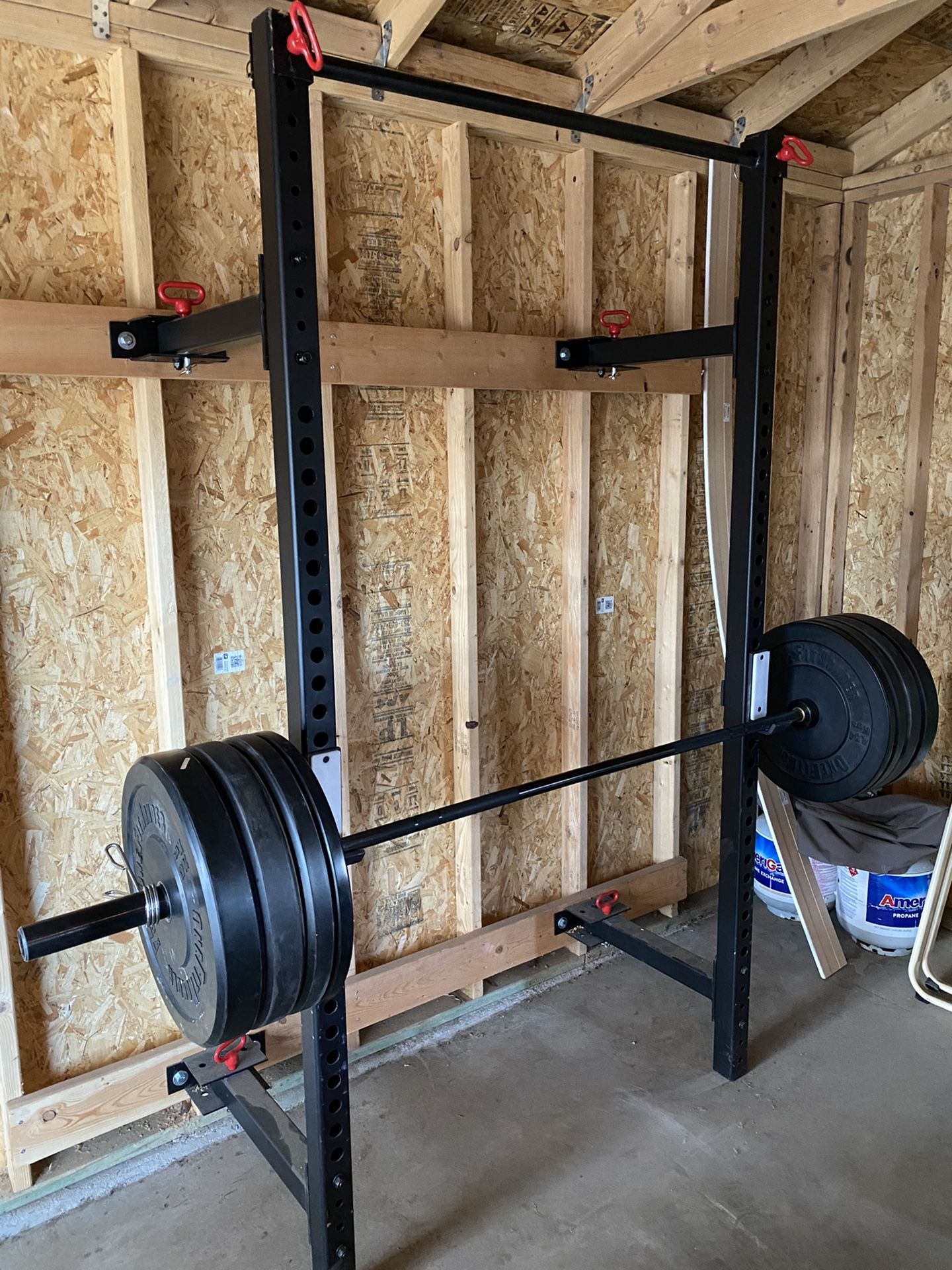 Wall-mounted Squat rack, Olympic barbell, 230 pounds of bumper plates