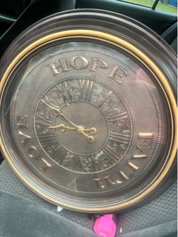 Two bronze clocks with quotes
