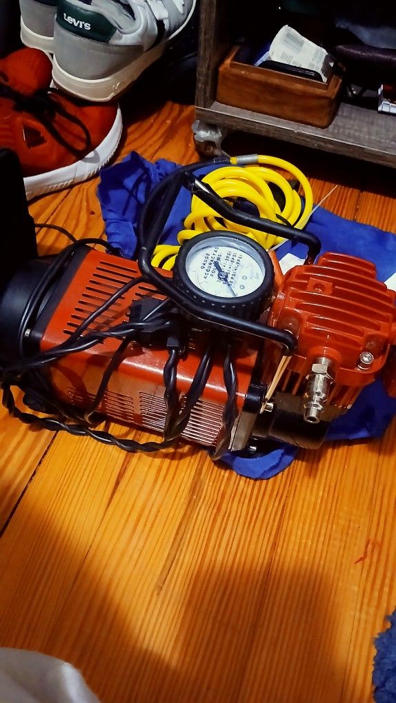 Portable Air Compressor And Connected With Jumping Cables Combined
