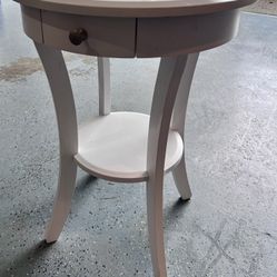 Round wood accent table with drawer and shelf