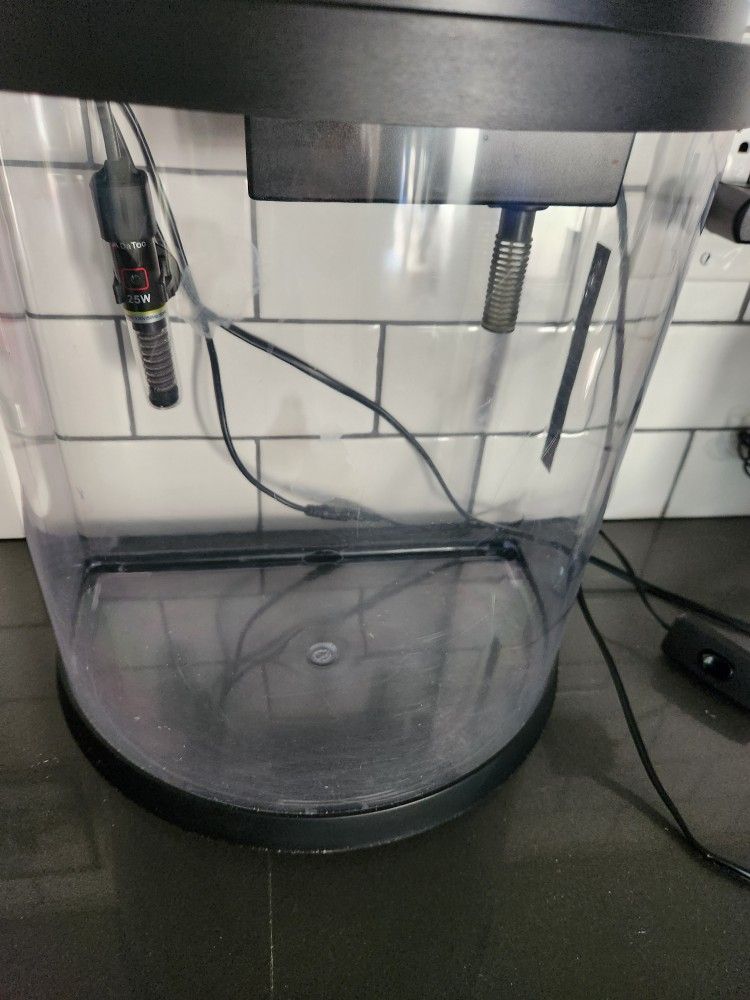 3.5 gallon Bowfront Fish Tank with extra filter cartridges.