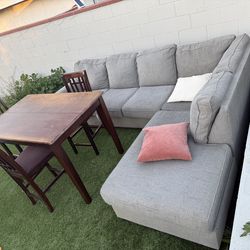 L shaped couch and dining table with 3 chairs