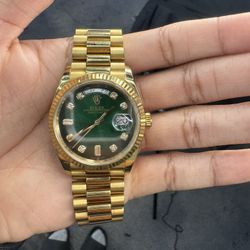 A Rolex Day-Date 36 in 18k yellow gold with a green ombré diamond dial