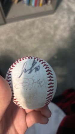 A used home in baseball in a reindeer game signed by two players A used home in baseball in a reindeer’s game, signed by two players