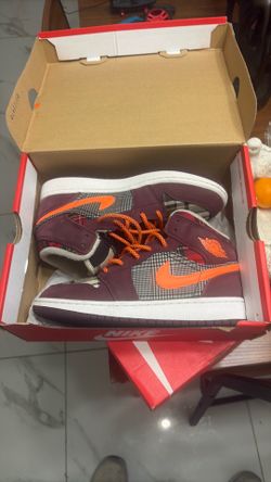 Nike Air Jordan 1 Mid SE "Plaid" Sneakers in Night Maroon and Total Orange.