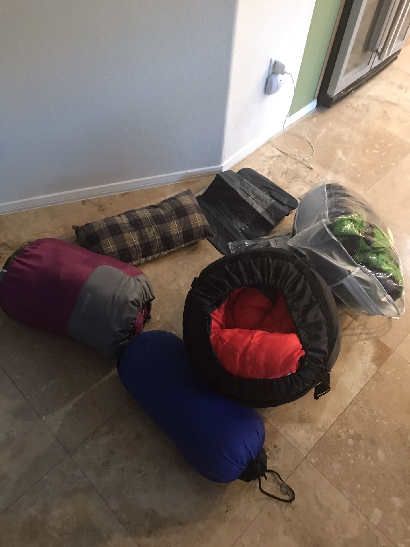 4 like new sleeping bags- 2 pillows-rain gaucho
