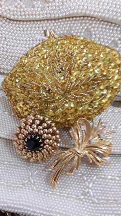 Gold sequin purse and two brooches.