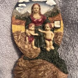Decorative figurine mother holding a book and two children