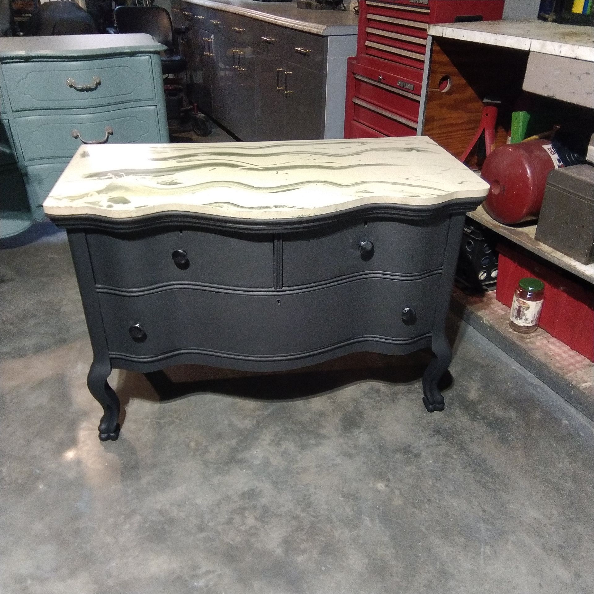 Wood cabinet painted black dove detailed drawers marble top