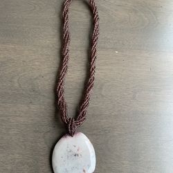 Vintage purple seed bead necklace with a round stone pendant